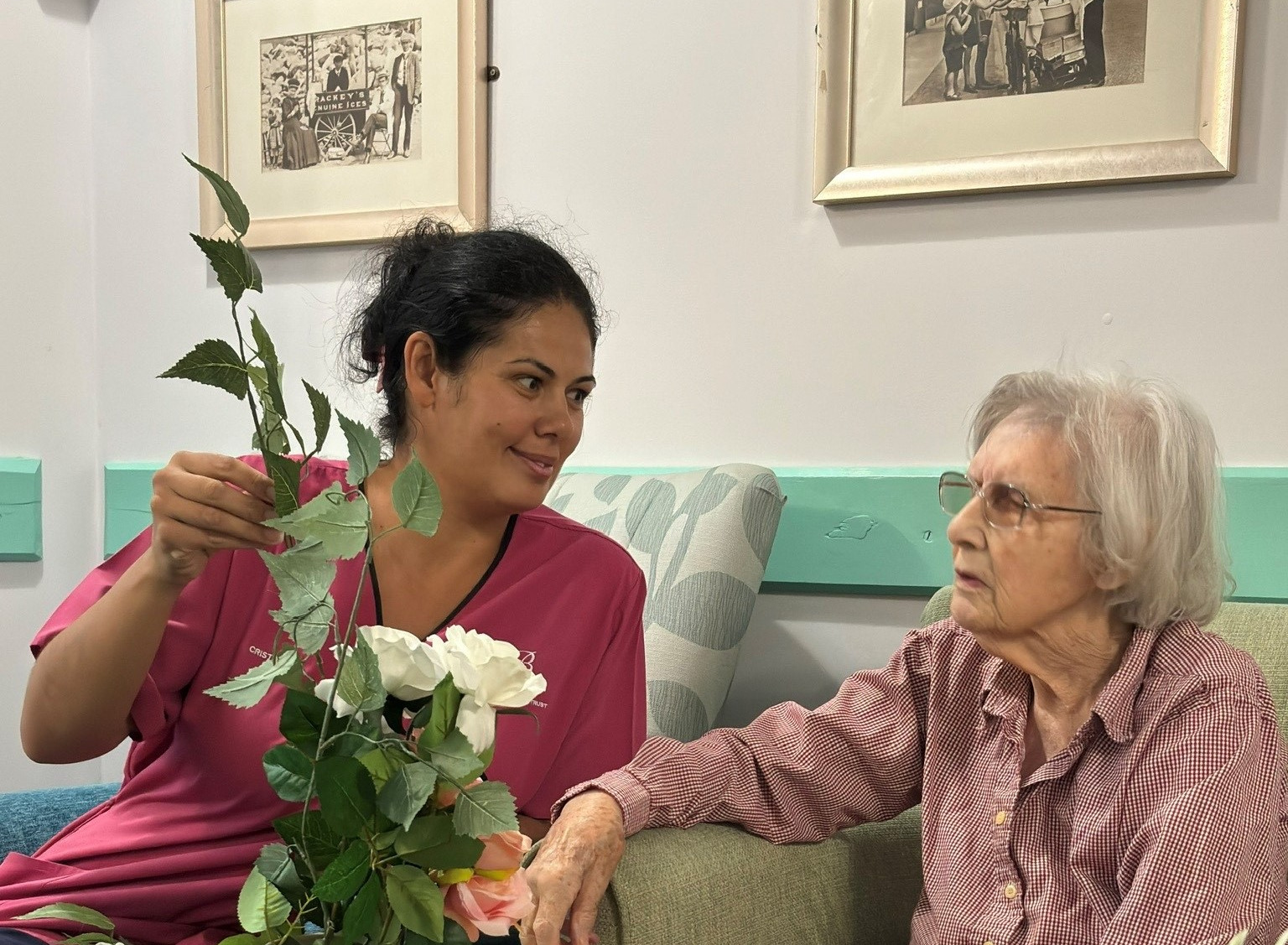 Two women with a flower