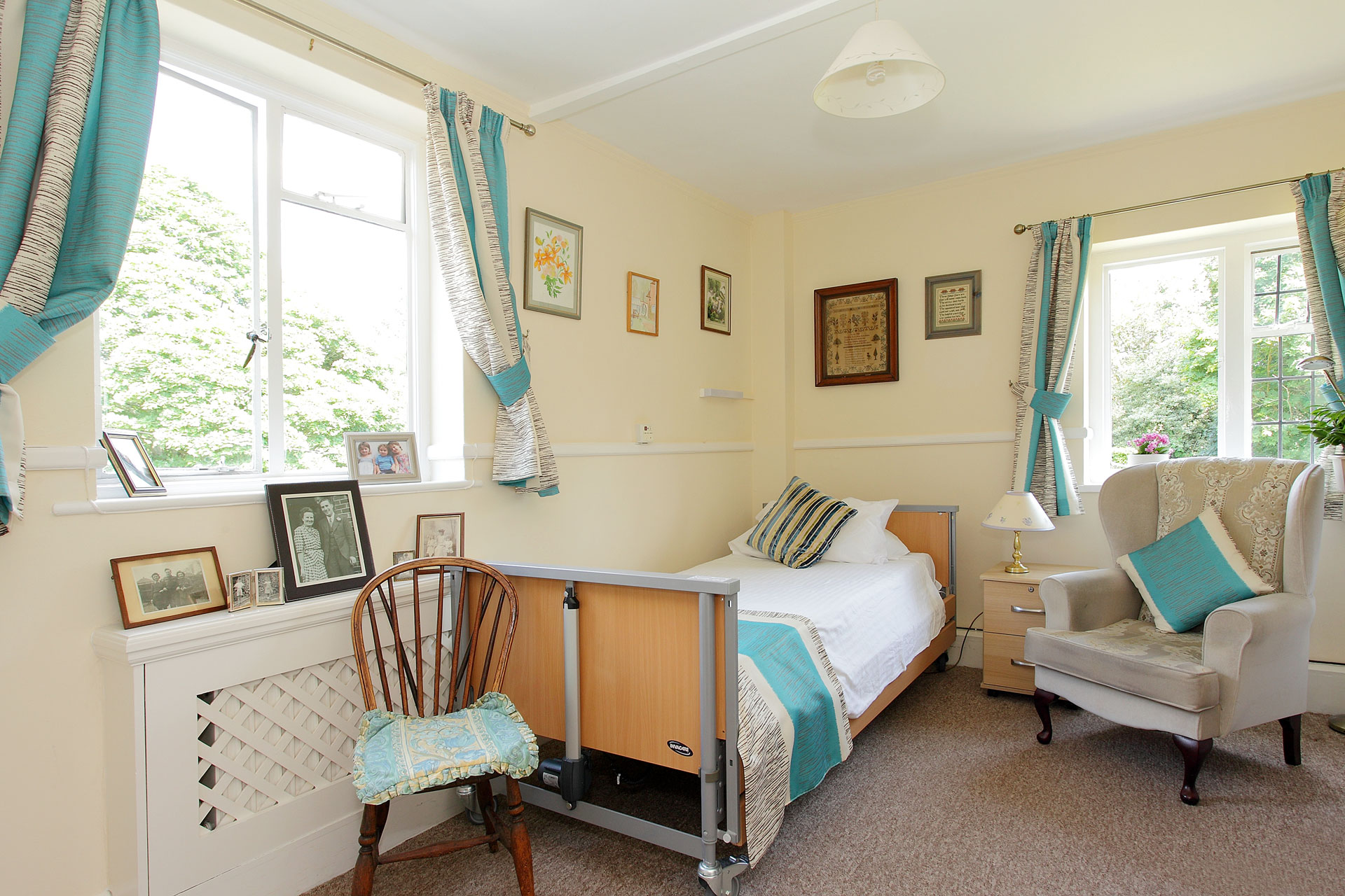 Bedroom with bed, furniture and photographs in frames