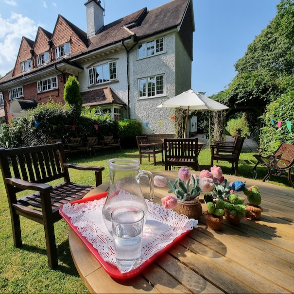 A sunny garden with refreshments on the garden table
