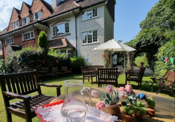 A sunny garden with refreshments on the garden table