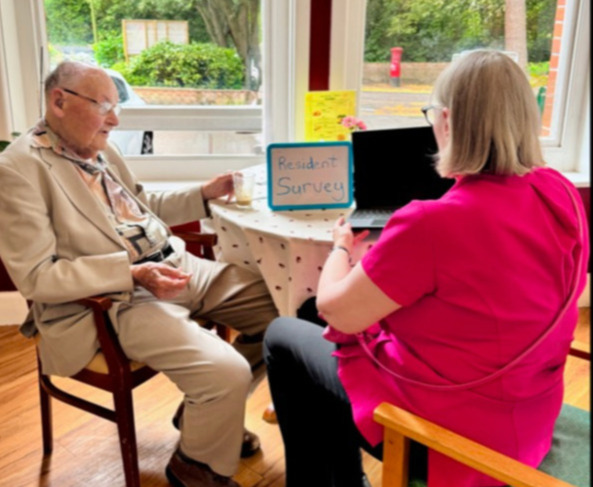 Resident and staff member sat having a conversation
