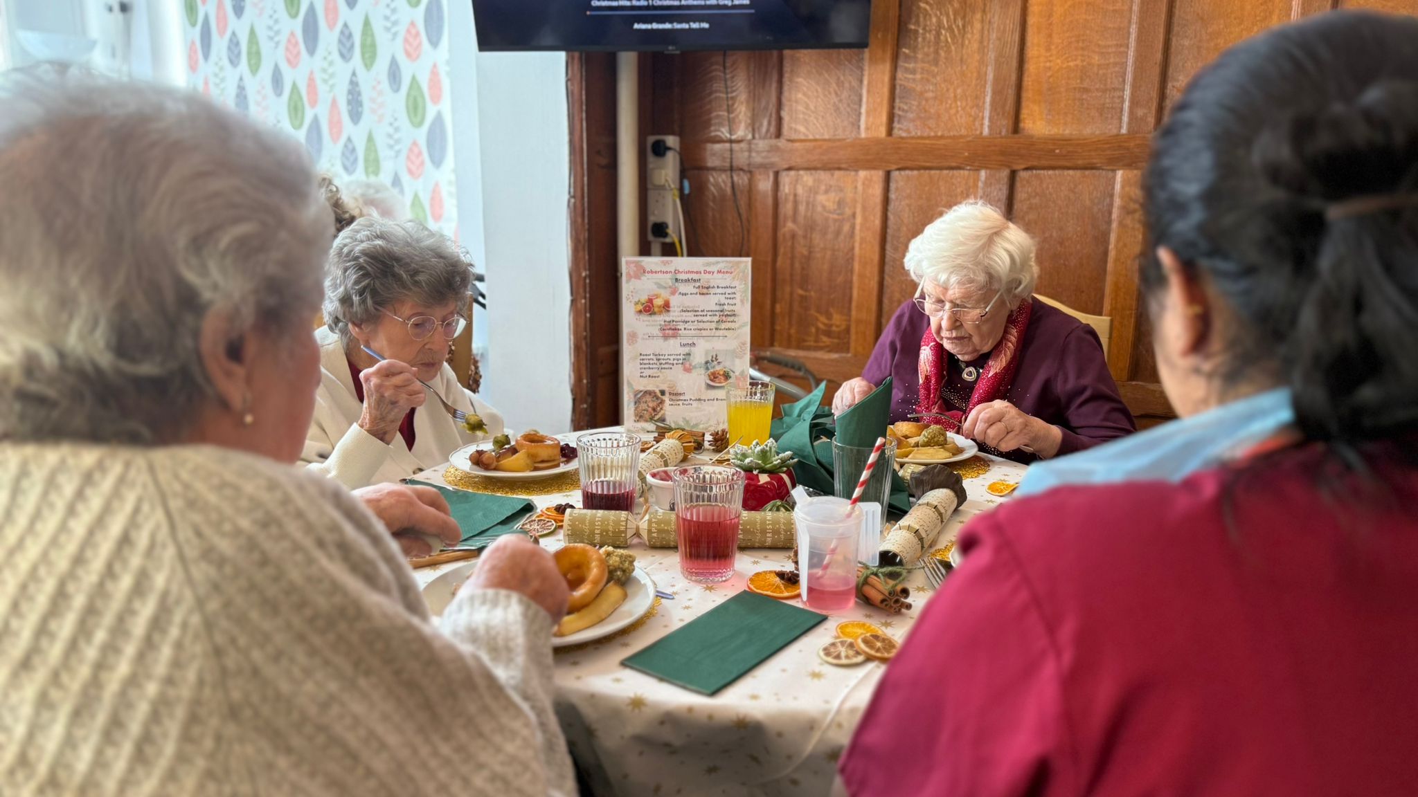 A group of people sat around a table eating a meal