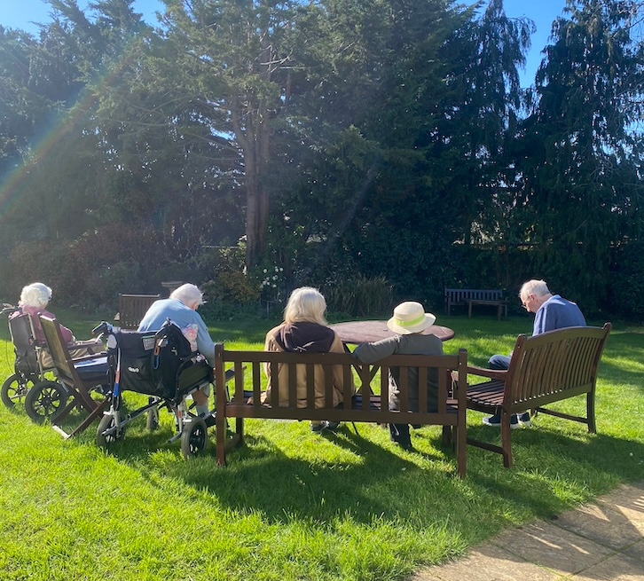 Elderly woman watering plants