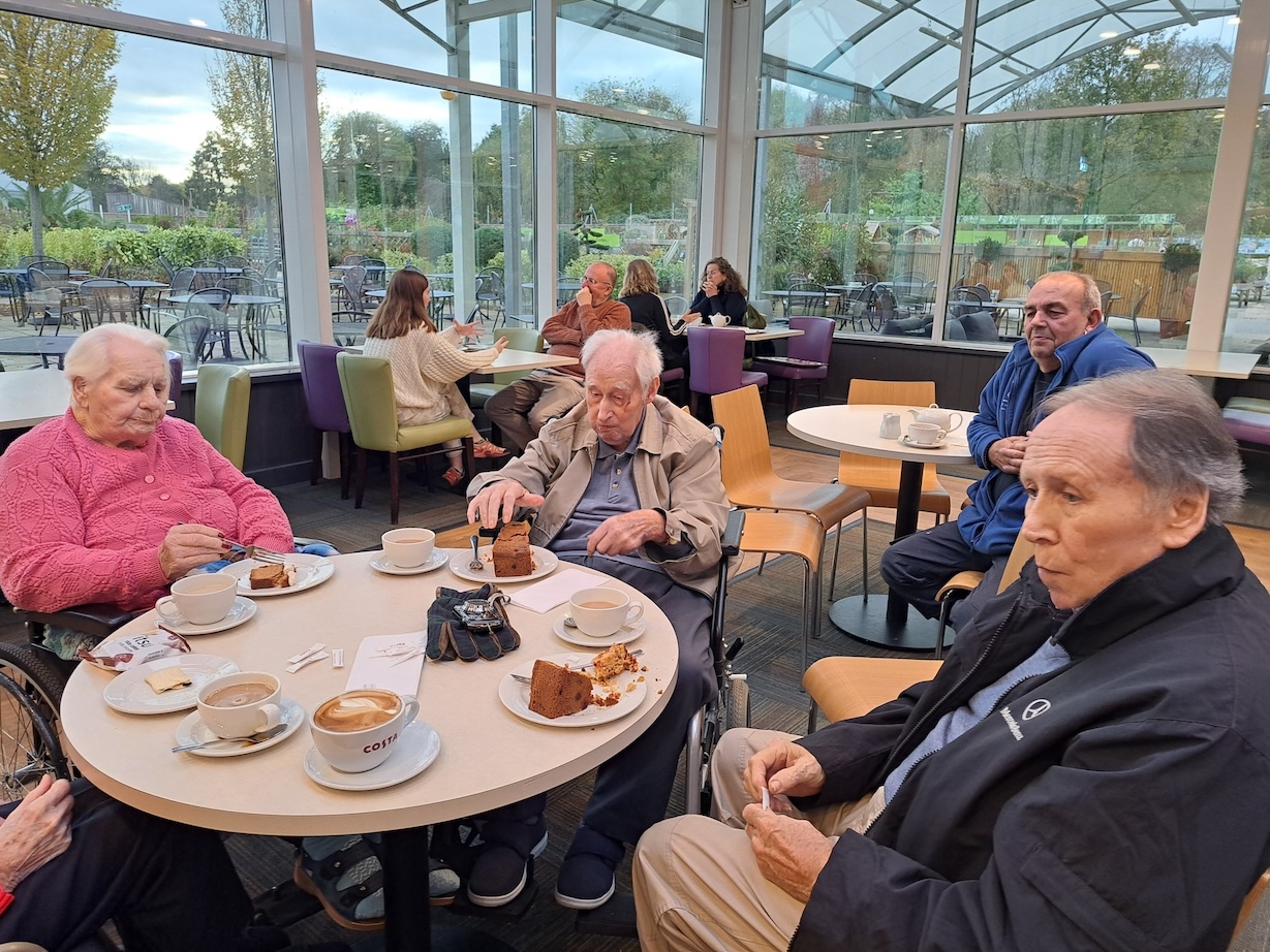 Group of people having tea and cake in a cafe