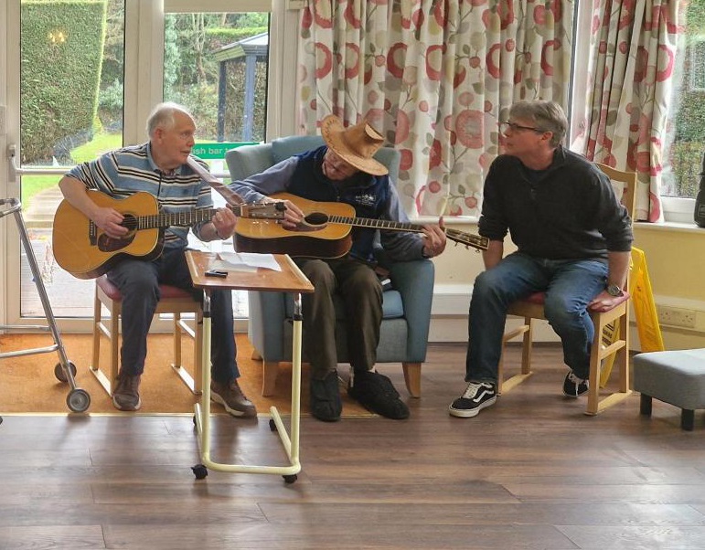 A group of men playing guitars