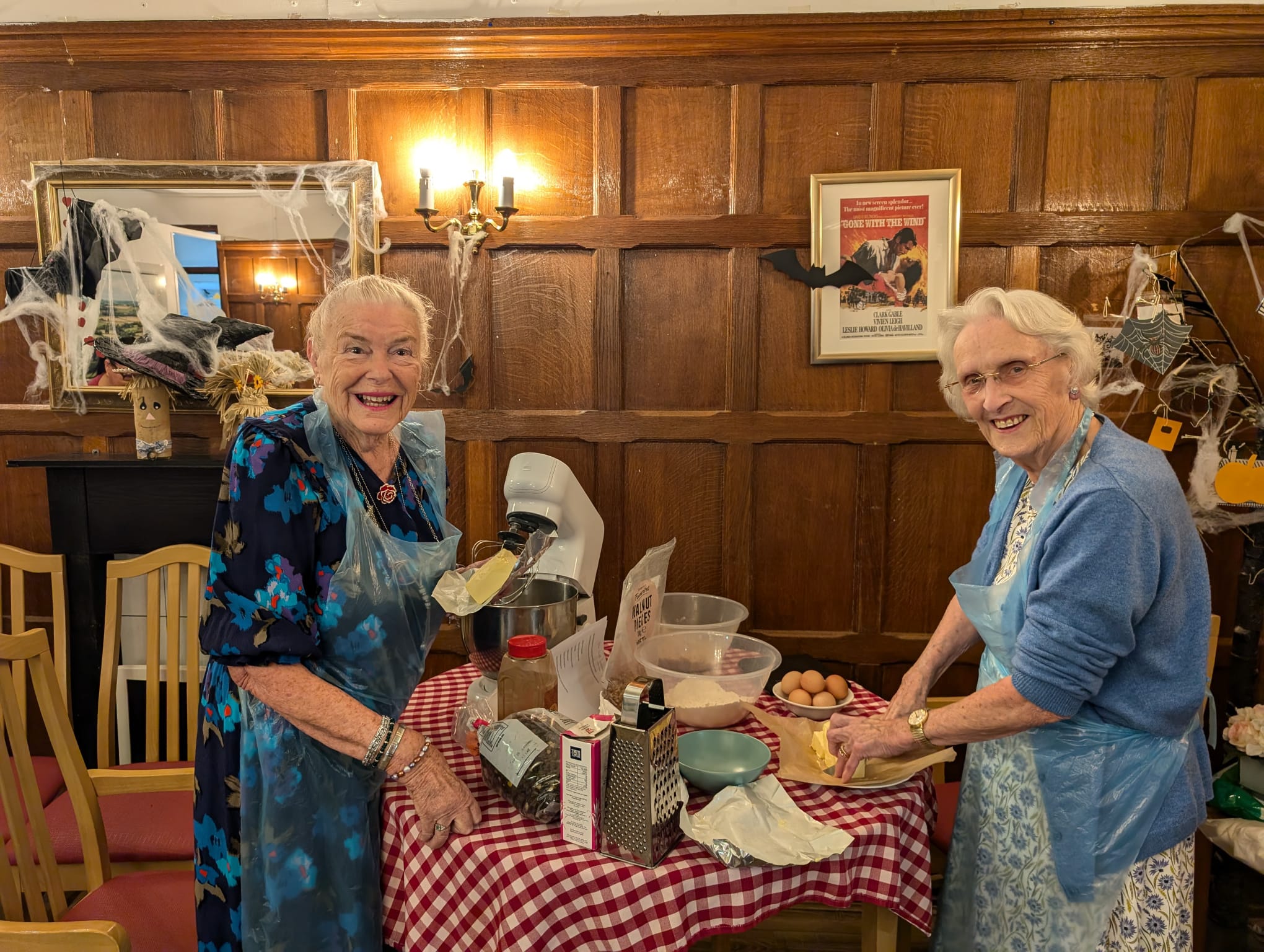 Two older women baking a cake