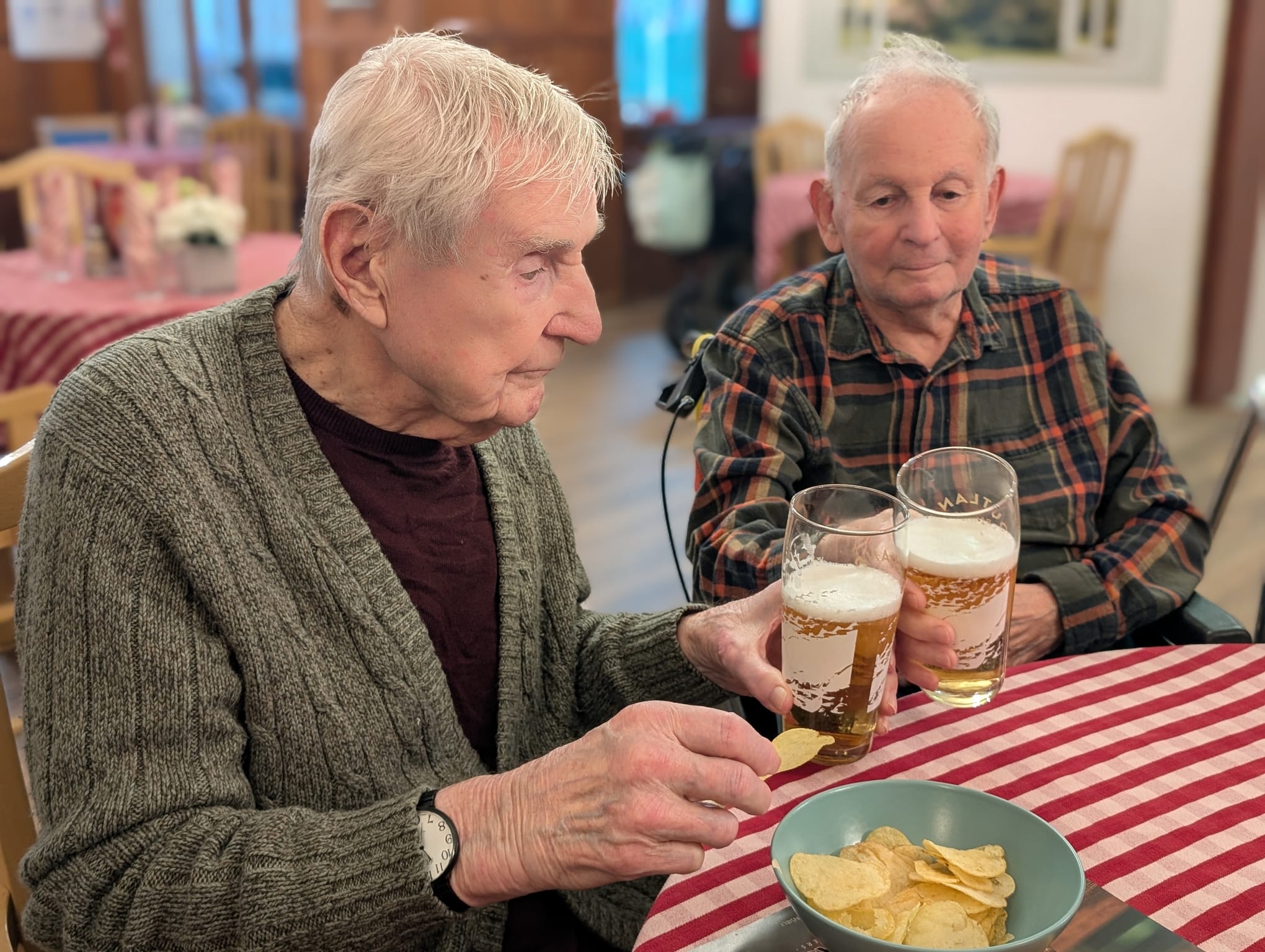 Two older gentleman enjoying a pint of beer together