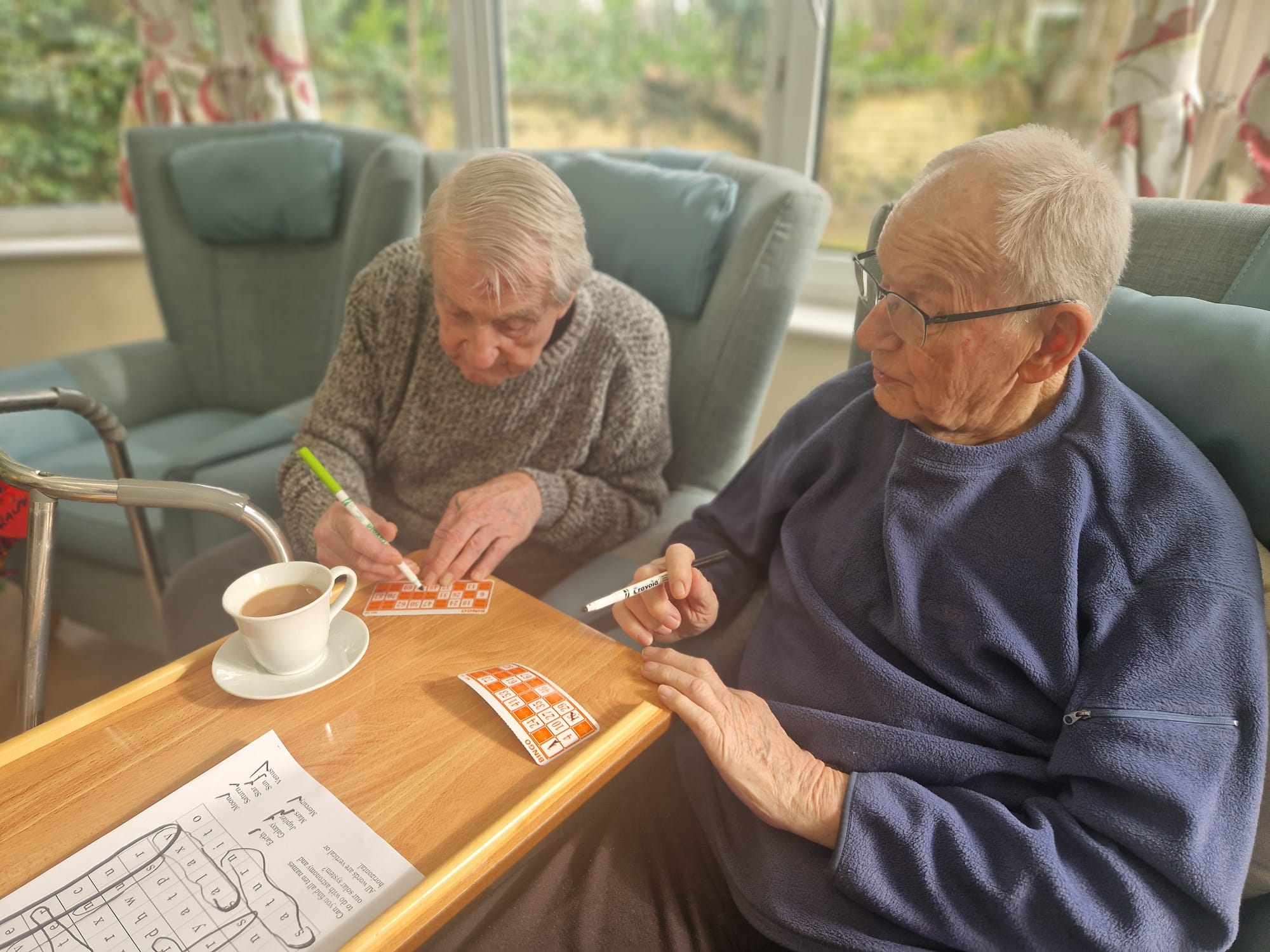 Two older gentleman sat playing bingo
