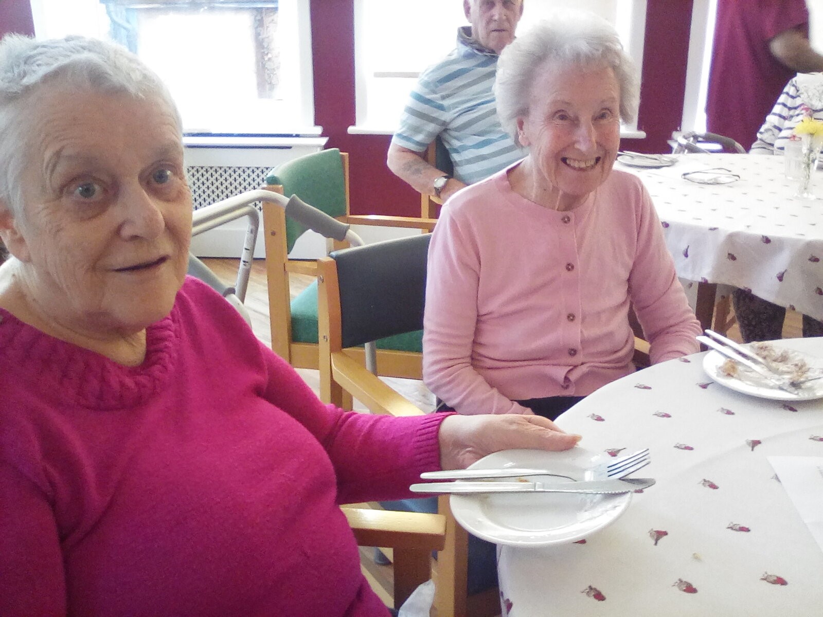 Two elderly ladies sat at a table 