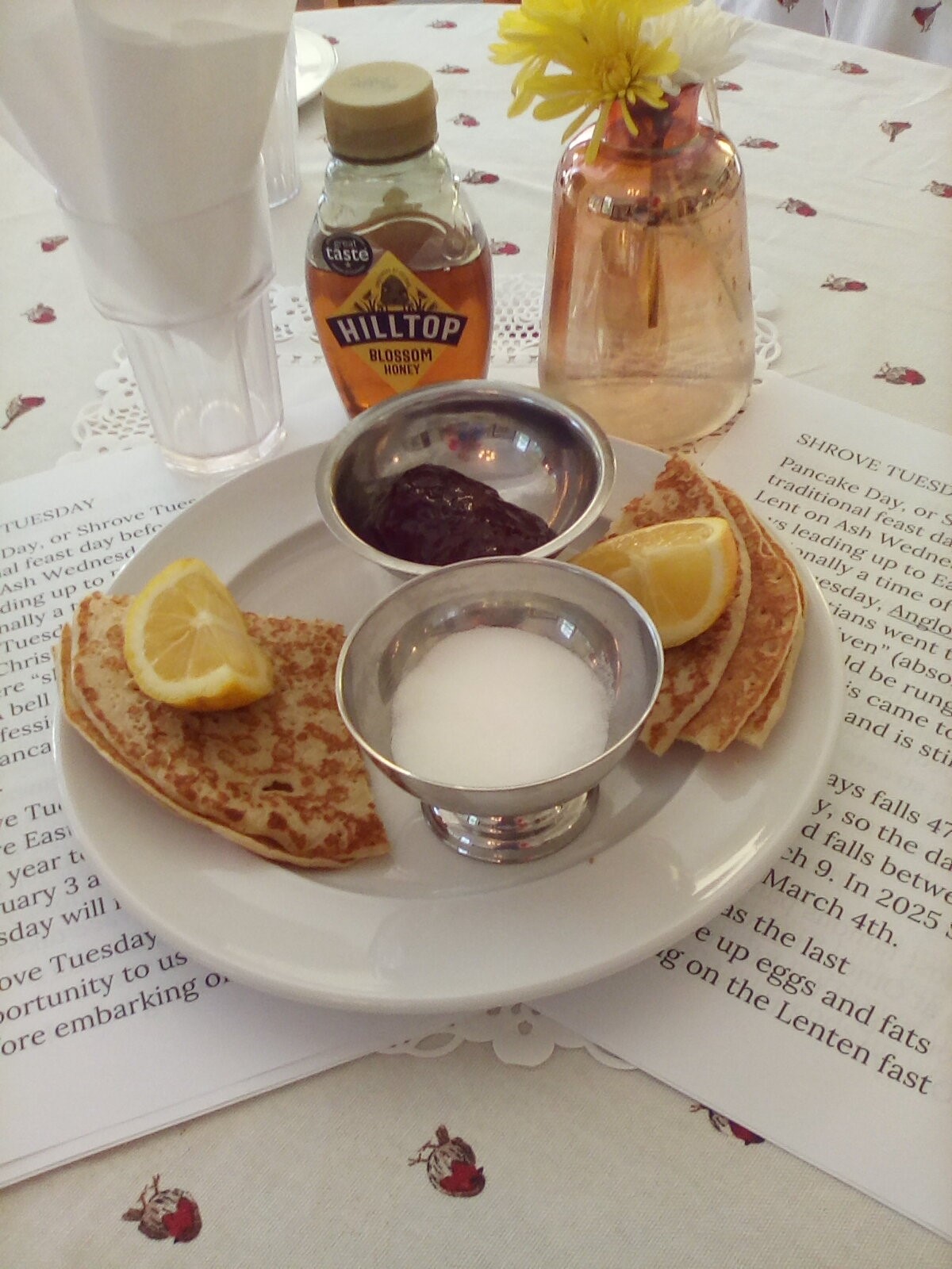 A plate of pancakes with lemon and sugar