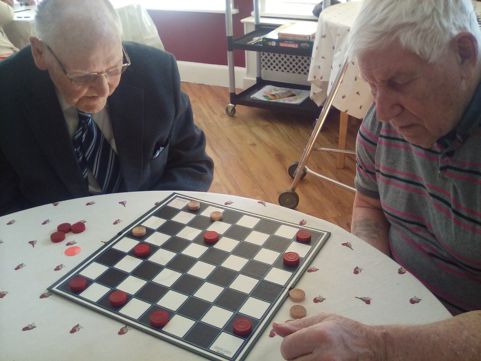 Two elderly gentlemen playing a board game