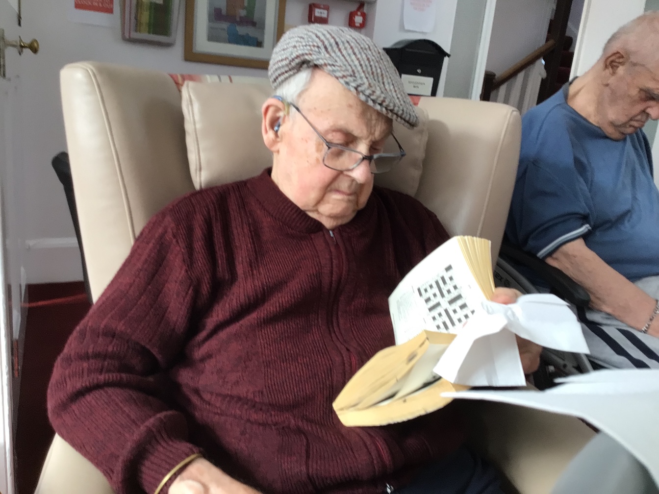An older gentleman reading a book