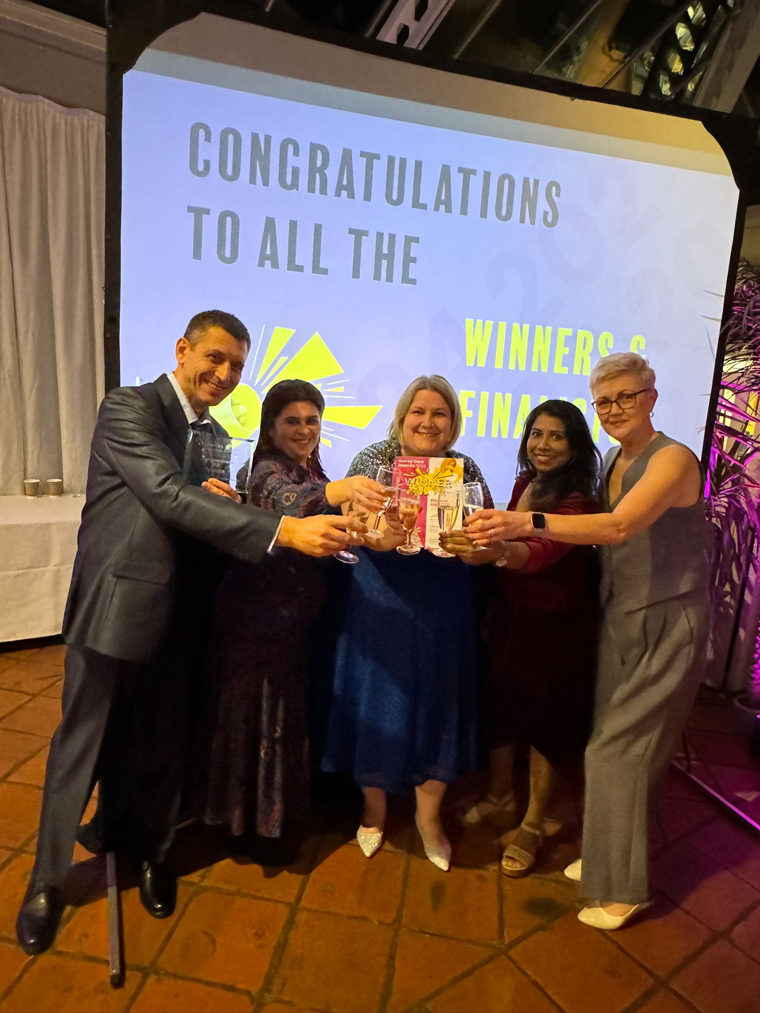 A group of people holding an award