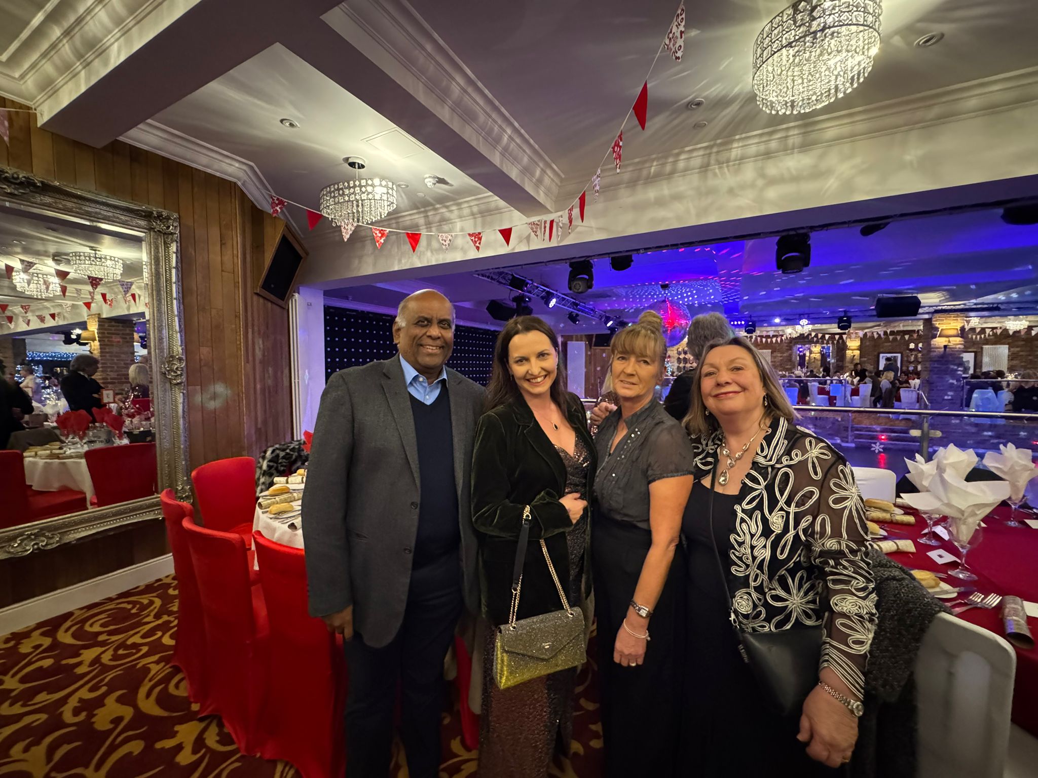 A group of smartly dressed people at a party 