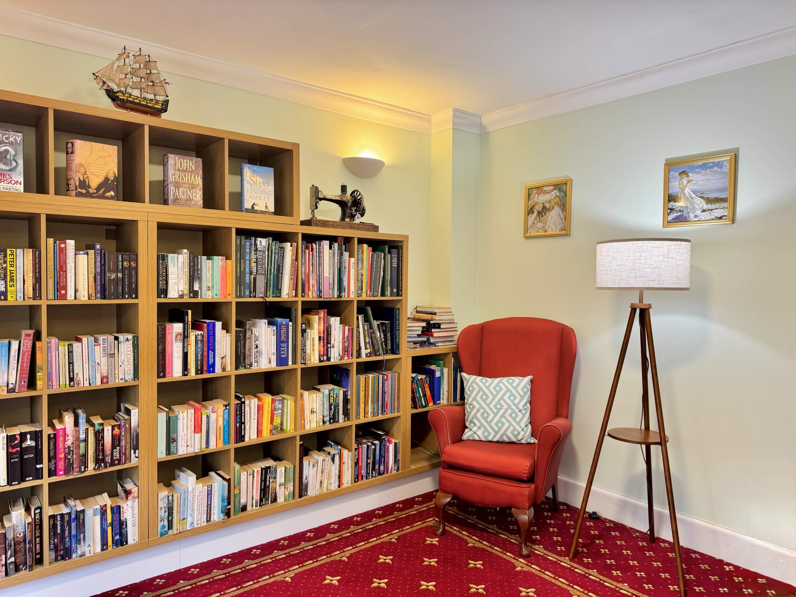 Library room with bookcases full of books and a comfortable armchair
