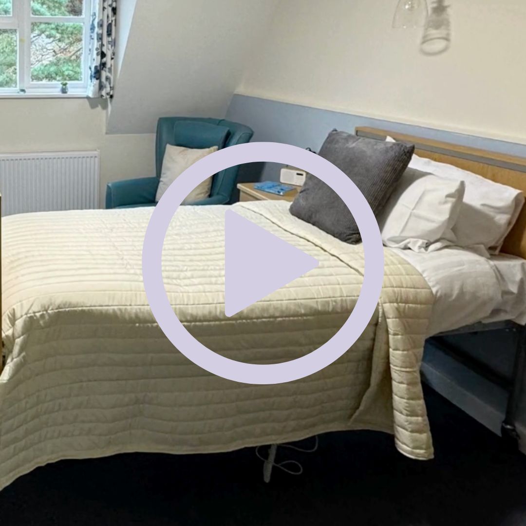 A resident bedrrom with bed and armchair