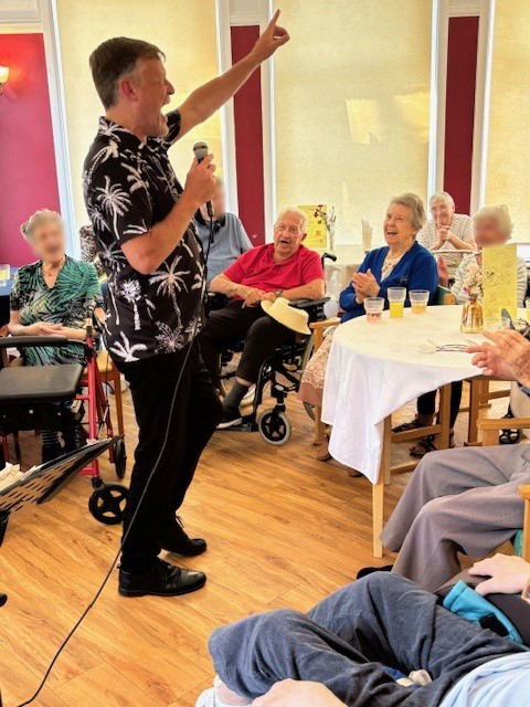 A group of people watching a singer perform