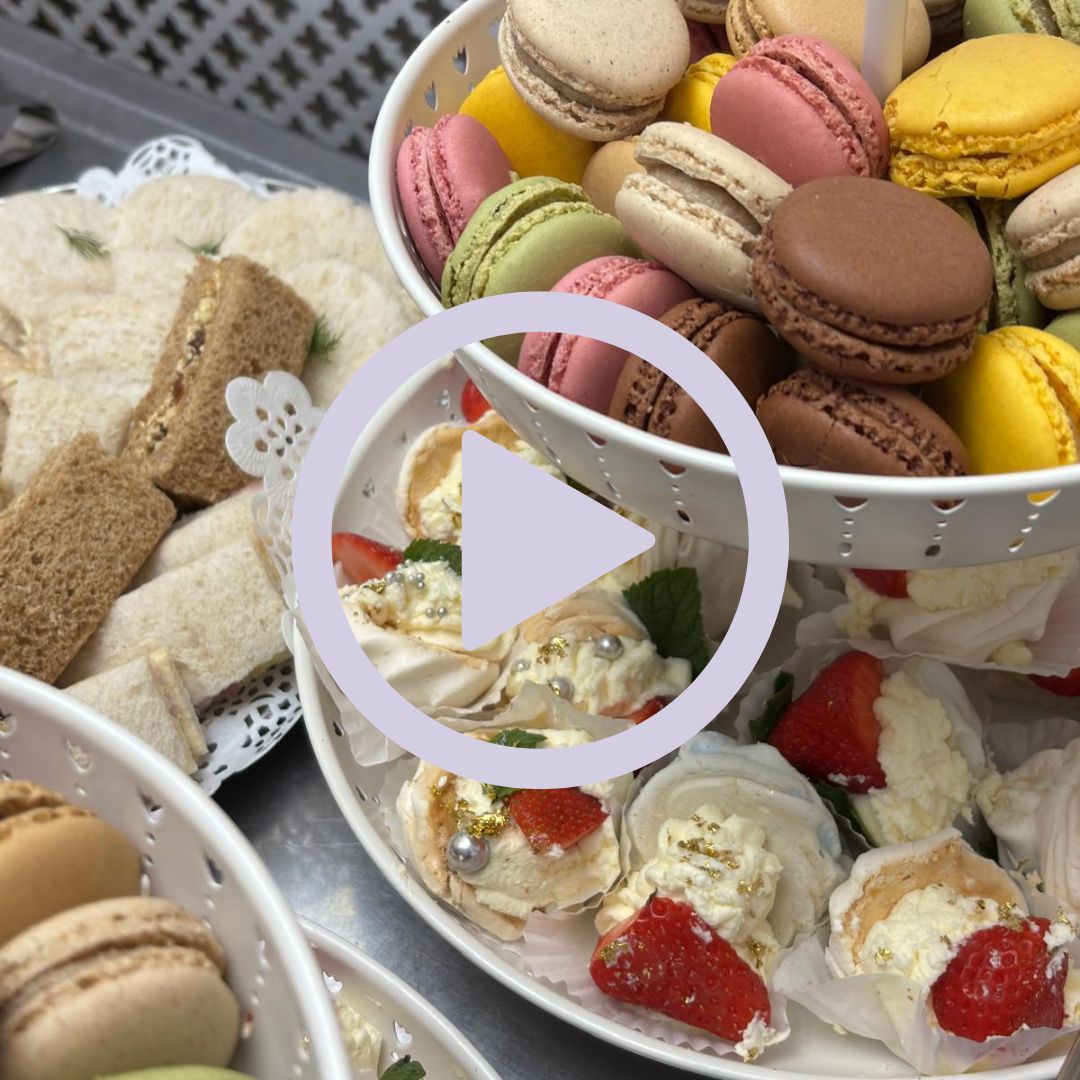 A table filled with sandwiches cakes and other party food