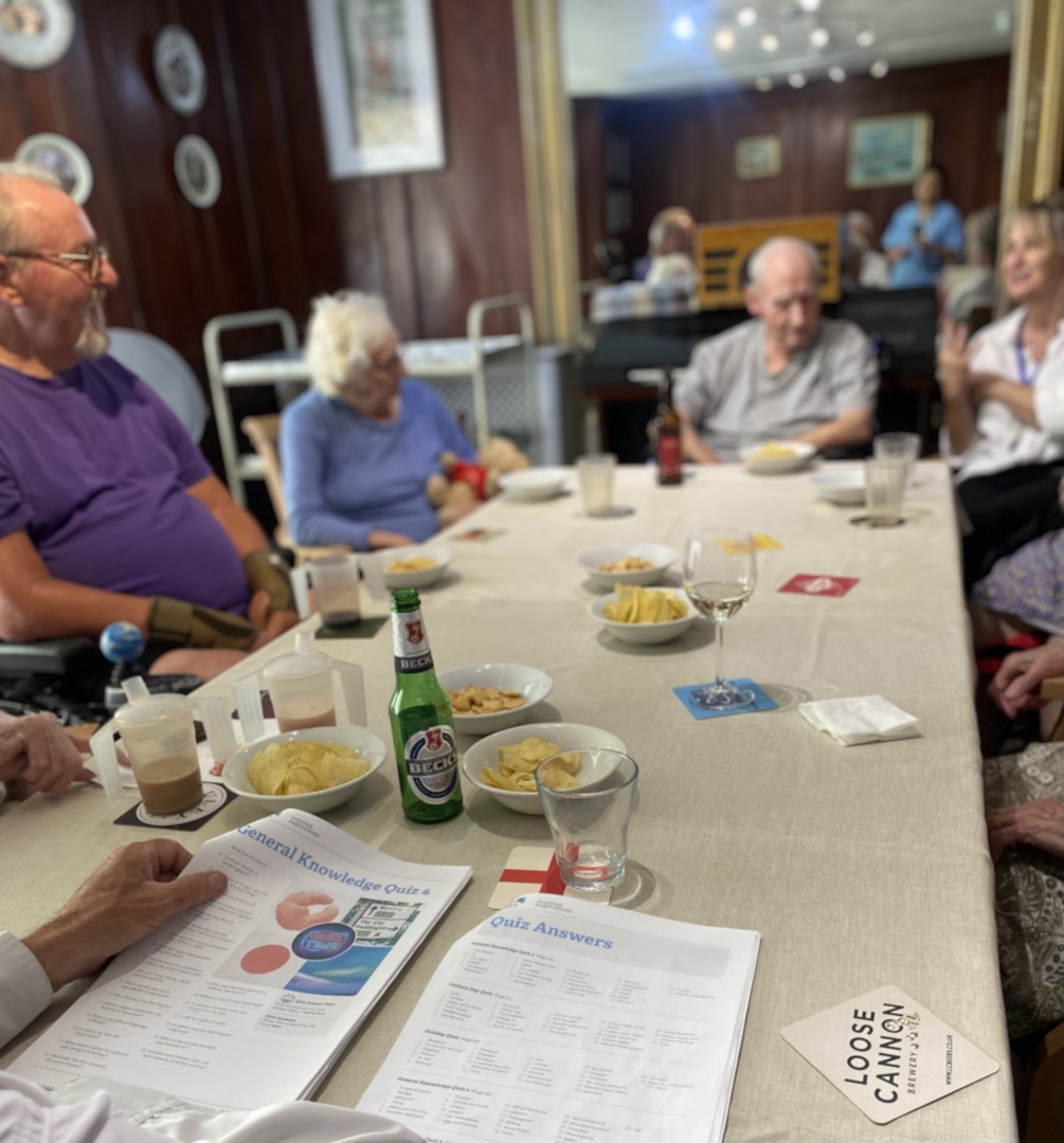A group of people sat around a table with refreshments