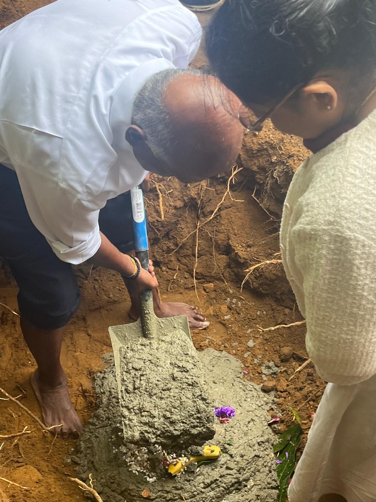 People digging the ground as part of a religious ceremony for a building project