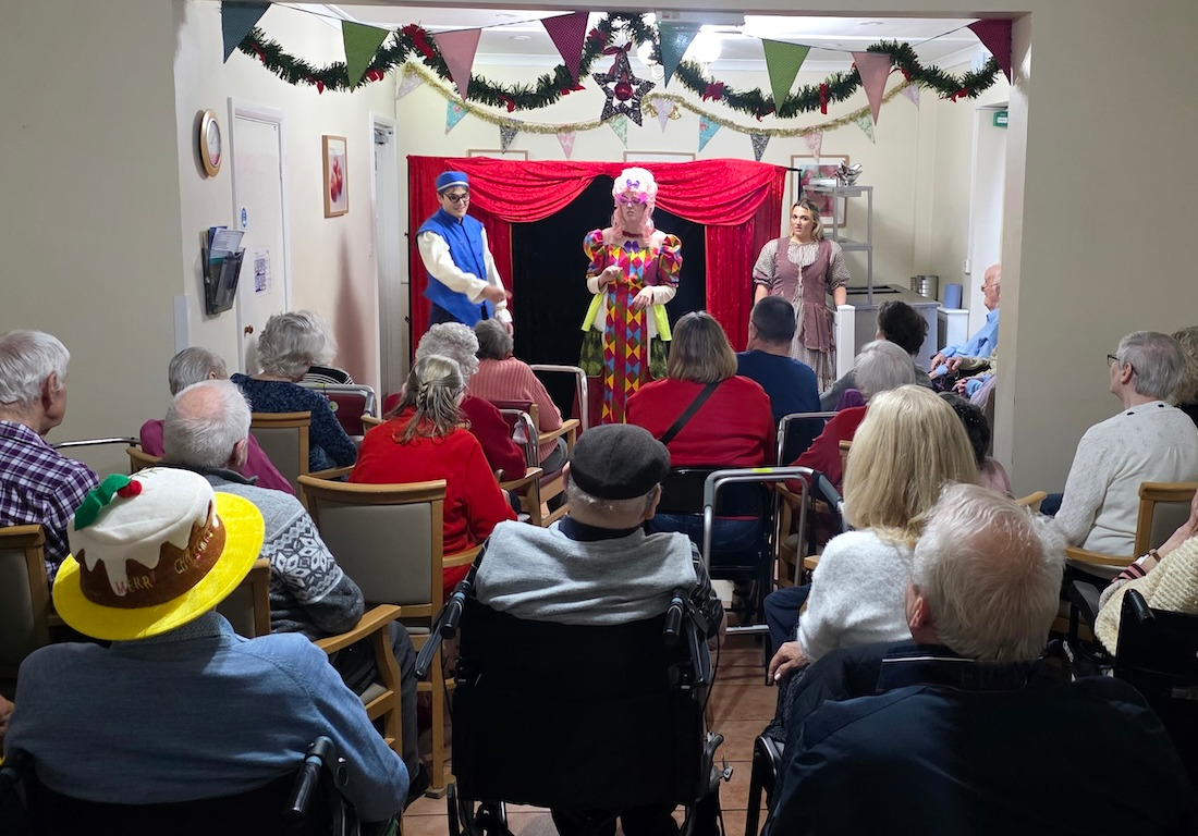 A group of people watching a pantomime performance