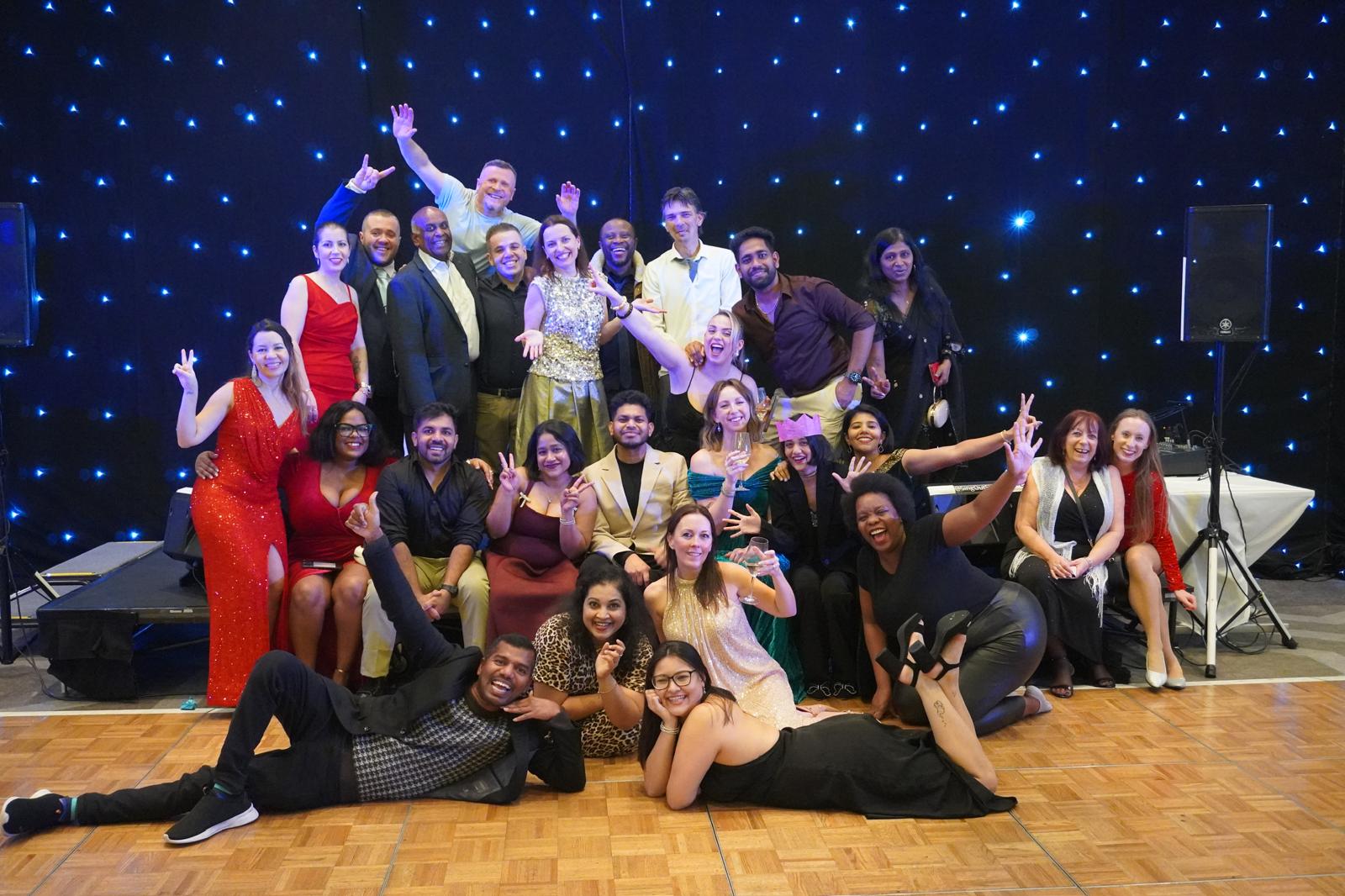 A group of people in formal wear at a Christmas party 
