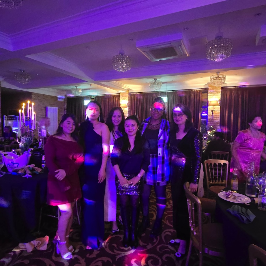 A group of people in formal wear at a Christmas party