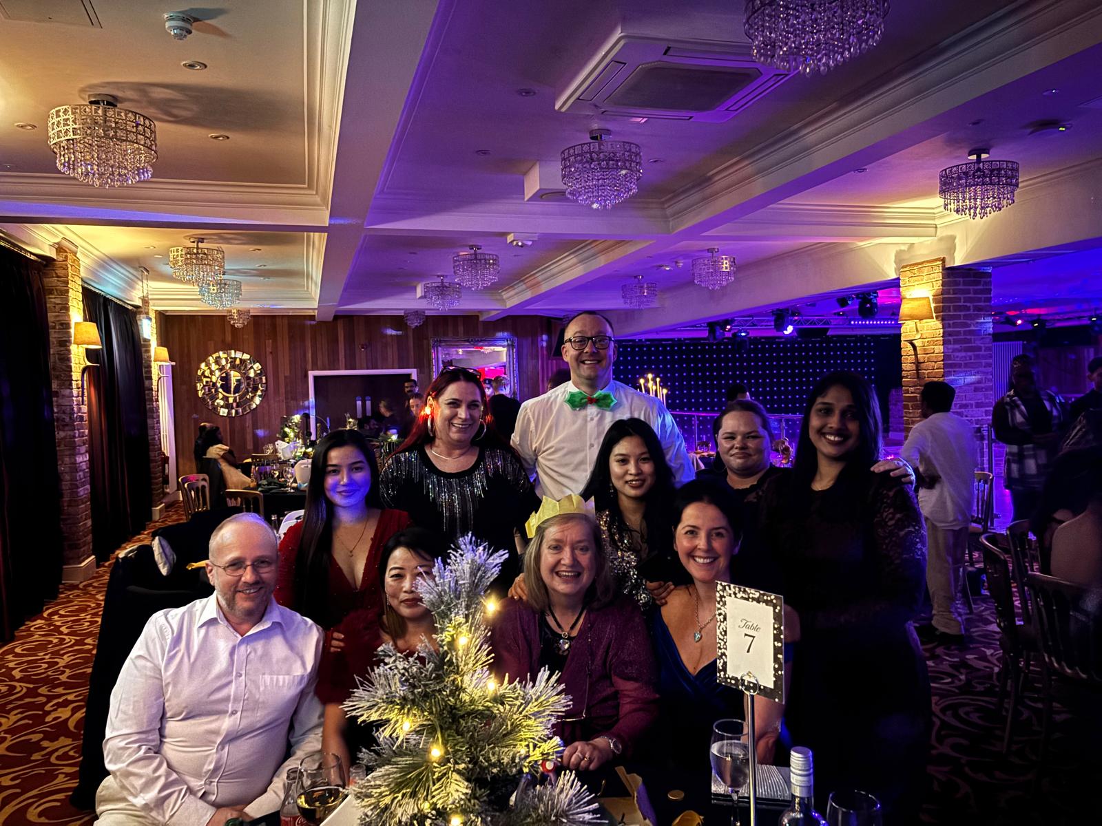 A group of people in formal wear at a Christmas party