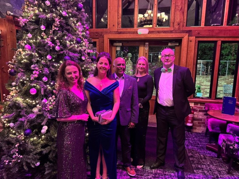 A group of people in formal wear at a Christmas party