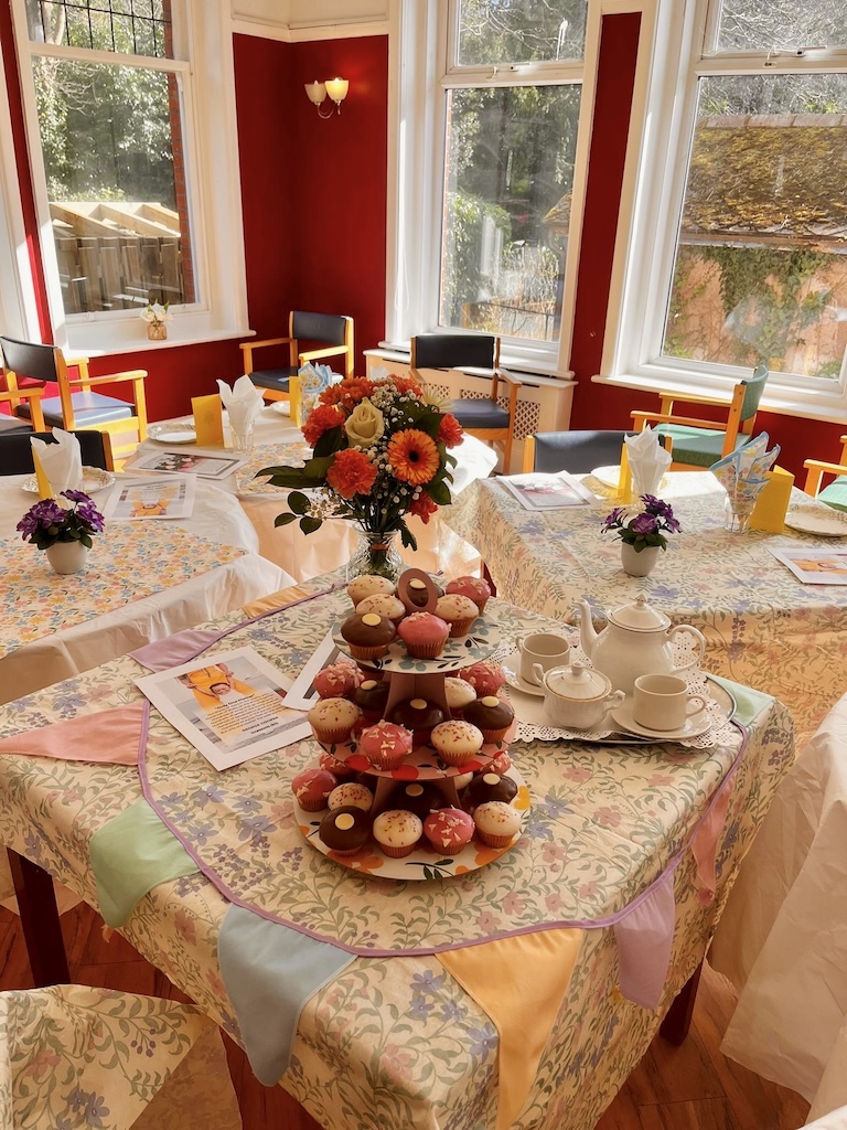A dining room with tables set up for afternoon tea