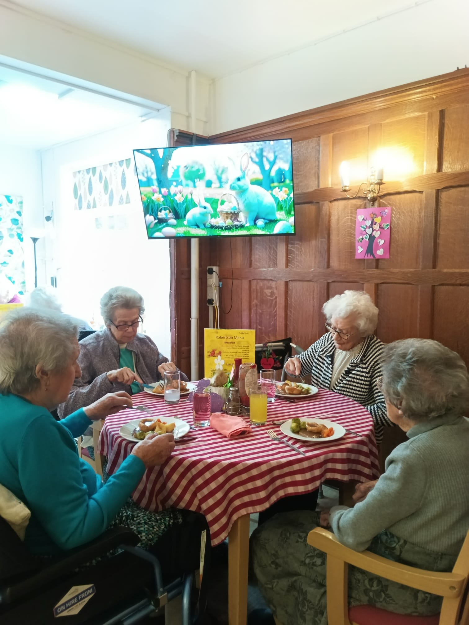 A group of people sat around a table eating a meal