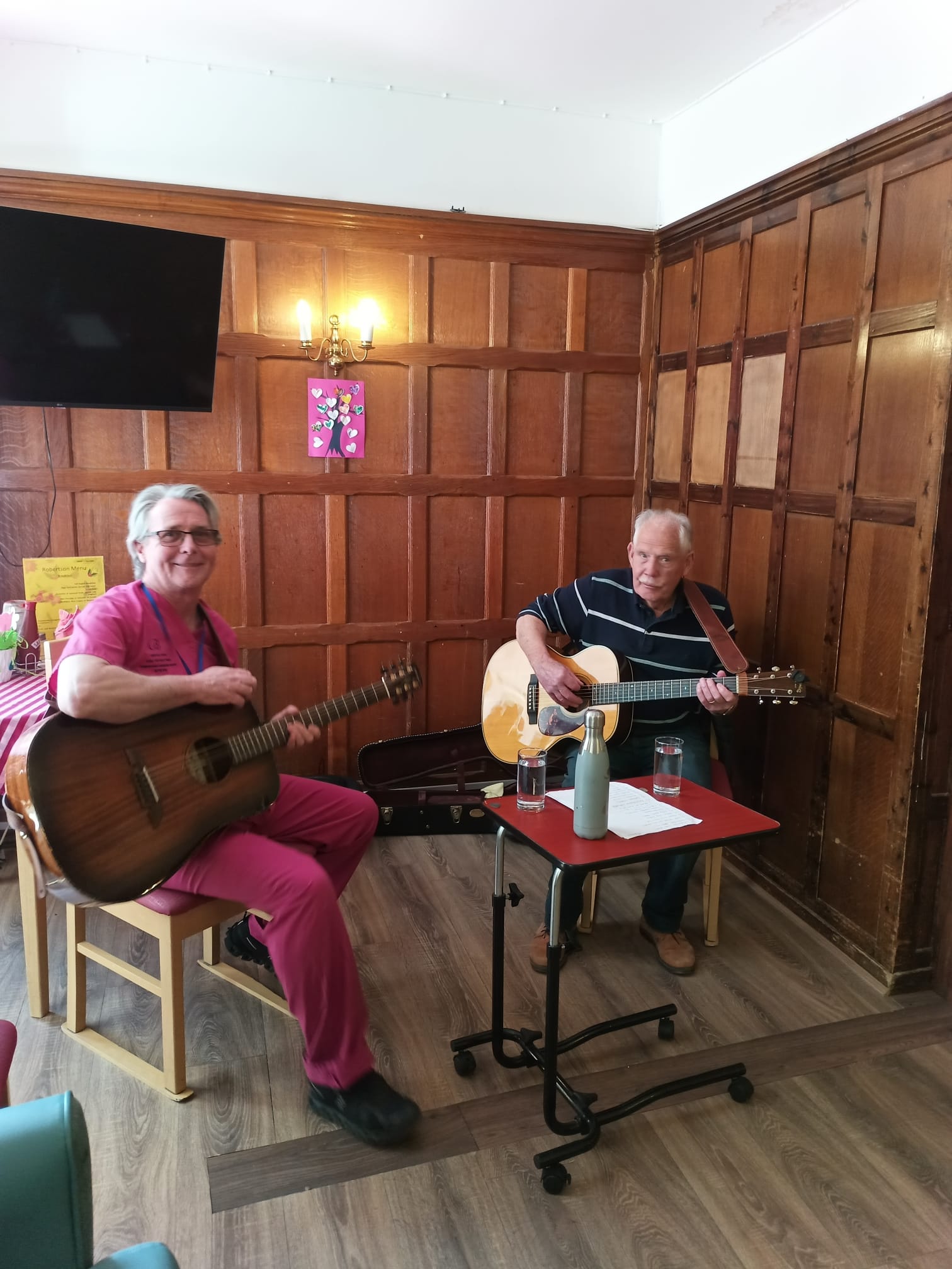 Two men holding guitars