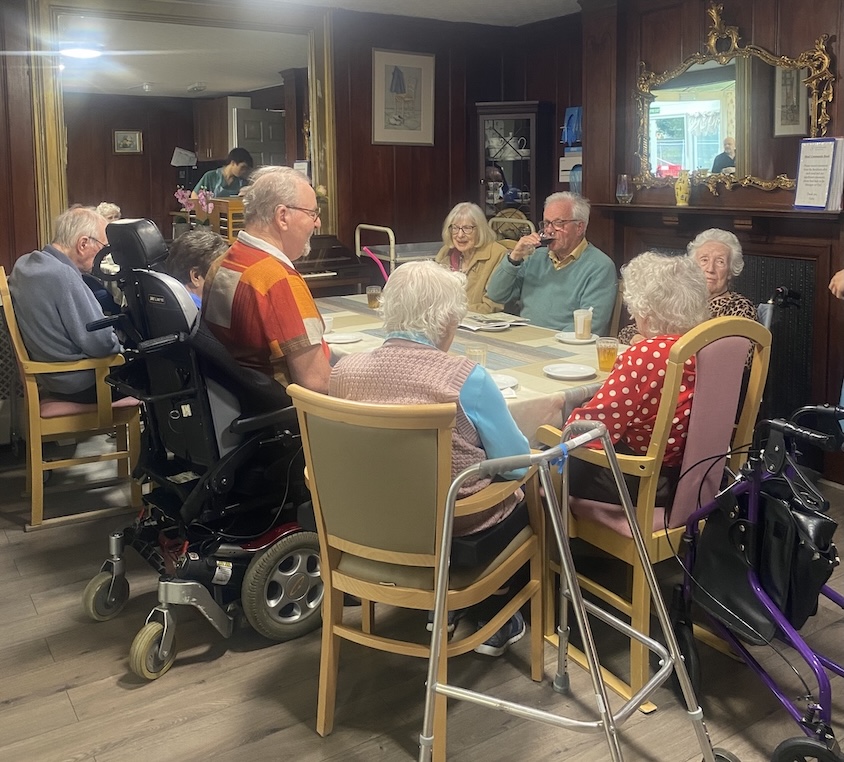 A group of people sat around a table 
