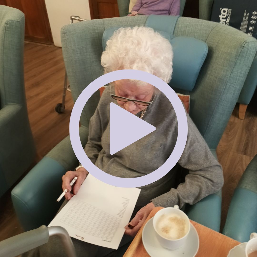 An elderly woman doing a crossword puzzle