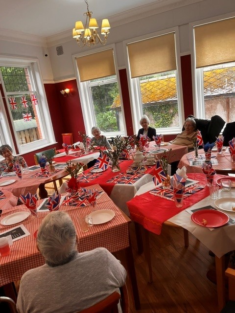A group of people sat at tables in a dining room 