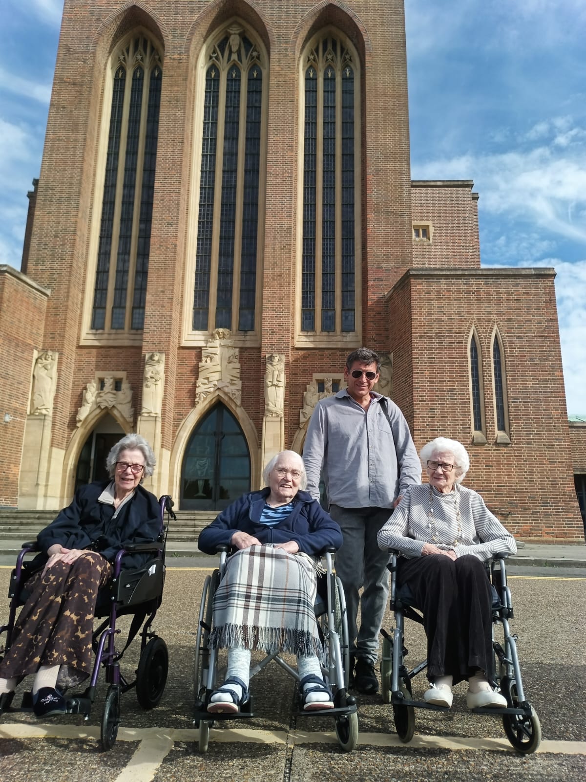 A group of people stood outside a cathedral