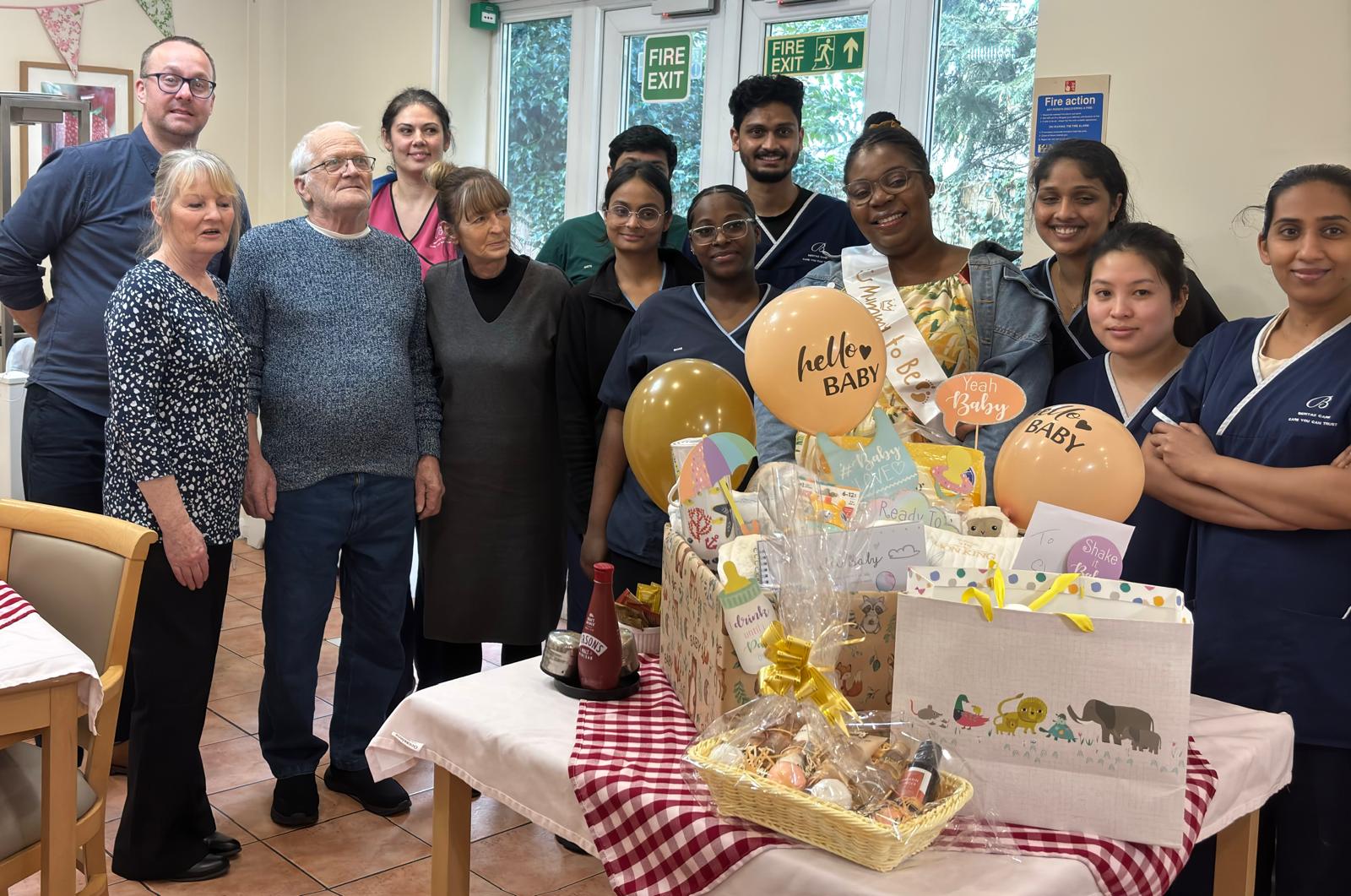 A group of people stood around a table of gifts.