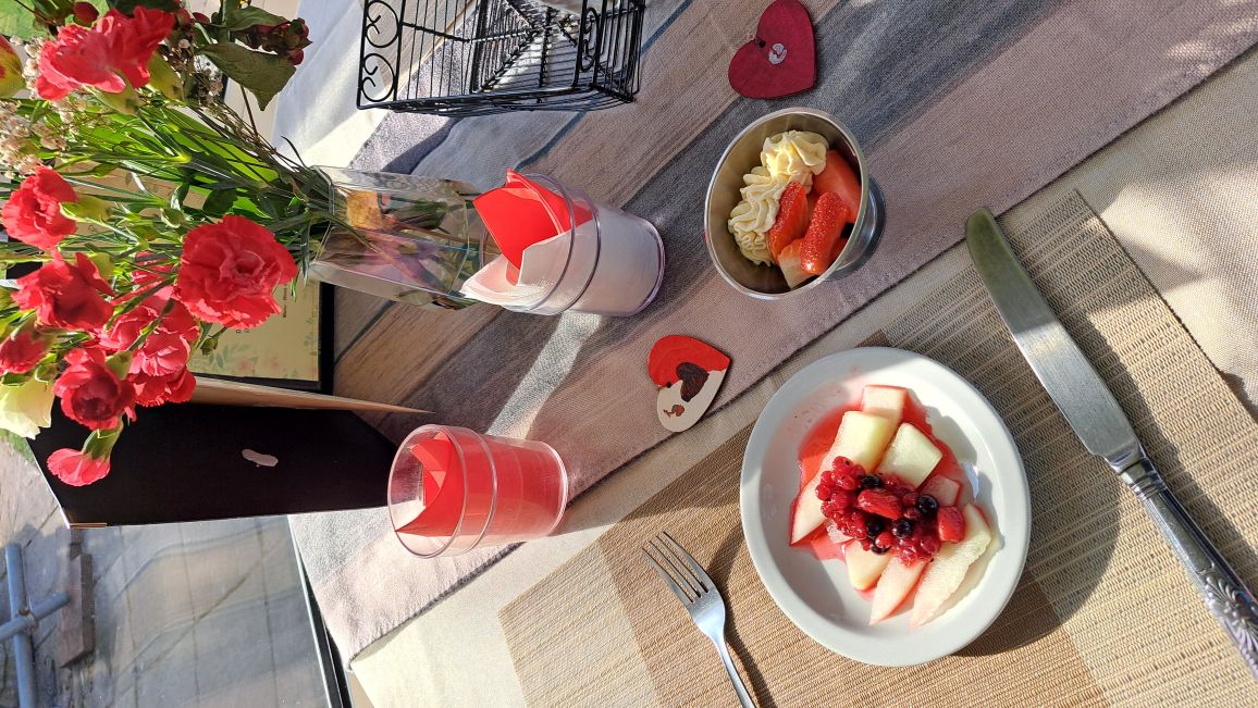 A nicely presented plate of food with a glass of a drink
