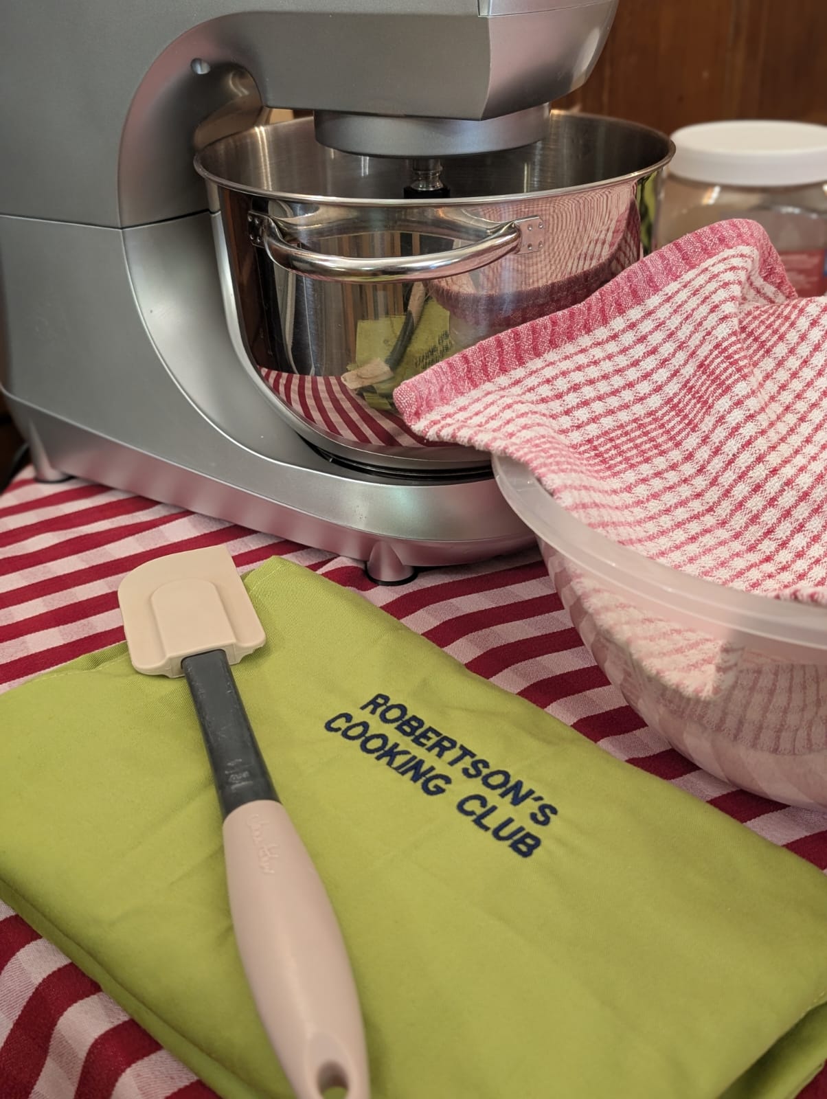 A branded towel in front of a mixer saying Robertson's cooking club