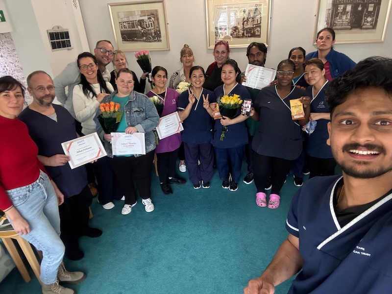 Group of care staff smiling and celebrating