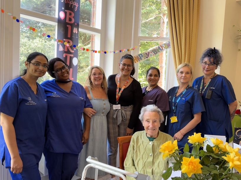 Group of staff members gathered to celebrate a birthday with a resident