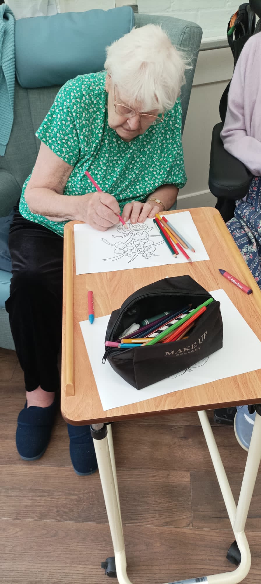 Older person doing some drawing on paper