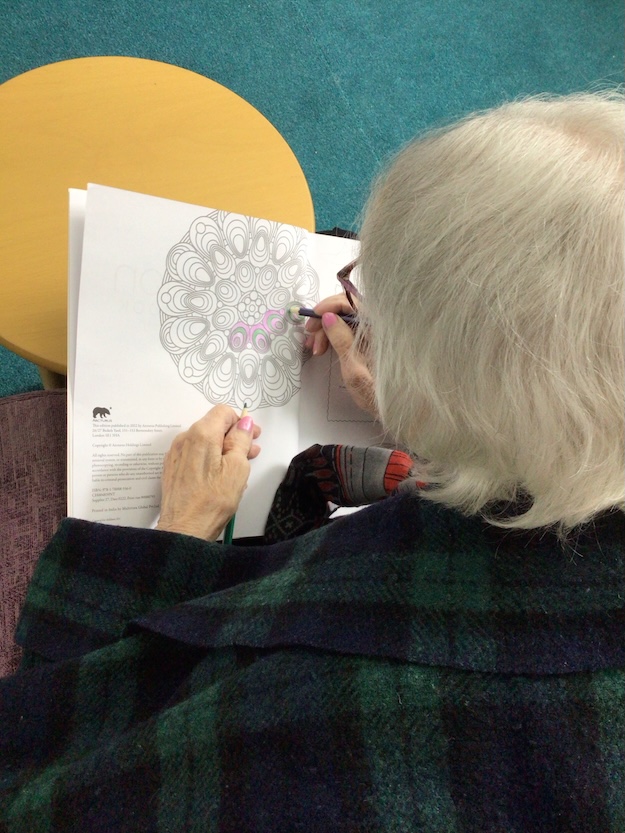 Elderly woman drawing a picture