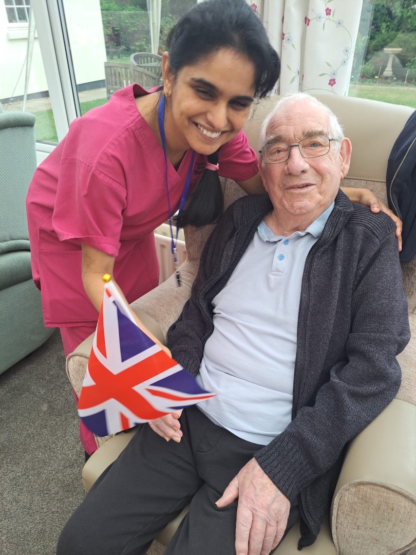 Staff member and resident smiling 