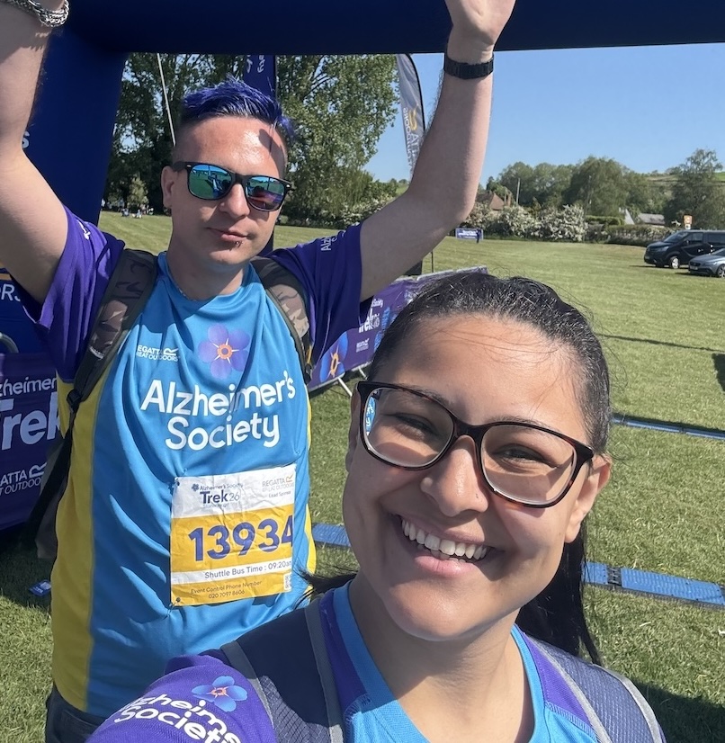 A man and woman in exercise clothing celebrating after completing a fundraising walk