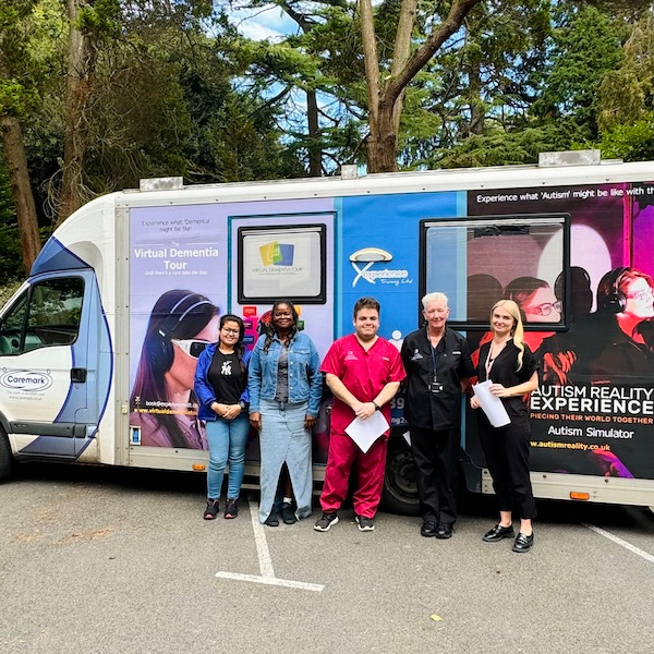 Staff members stood outside of a van after taking part in speclialist training