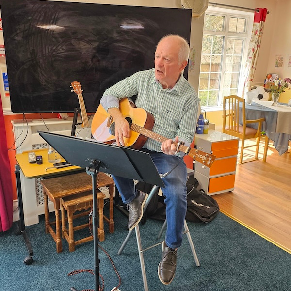 A gentleman playing a guitar