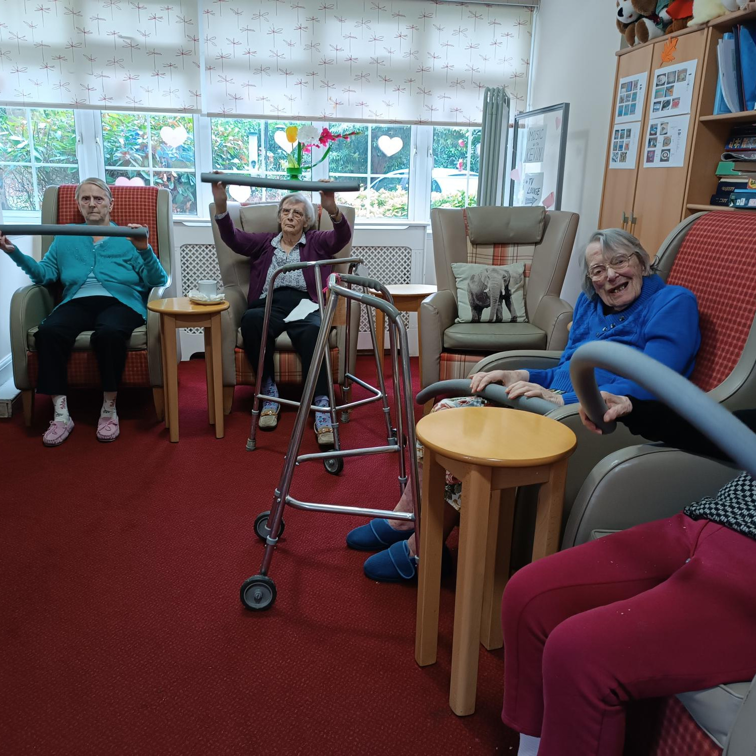 A group of older people taking part in chair based exercises
