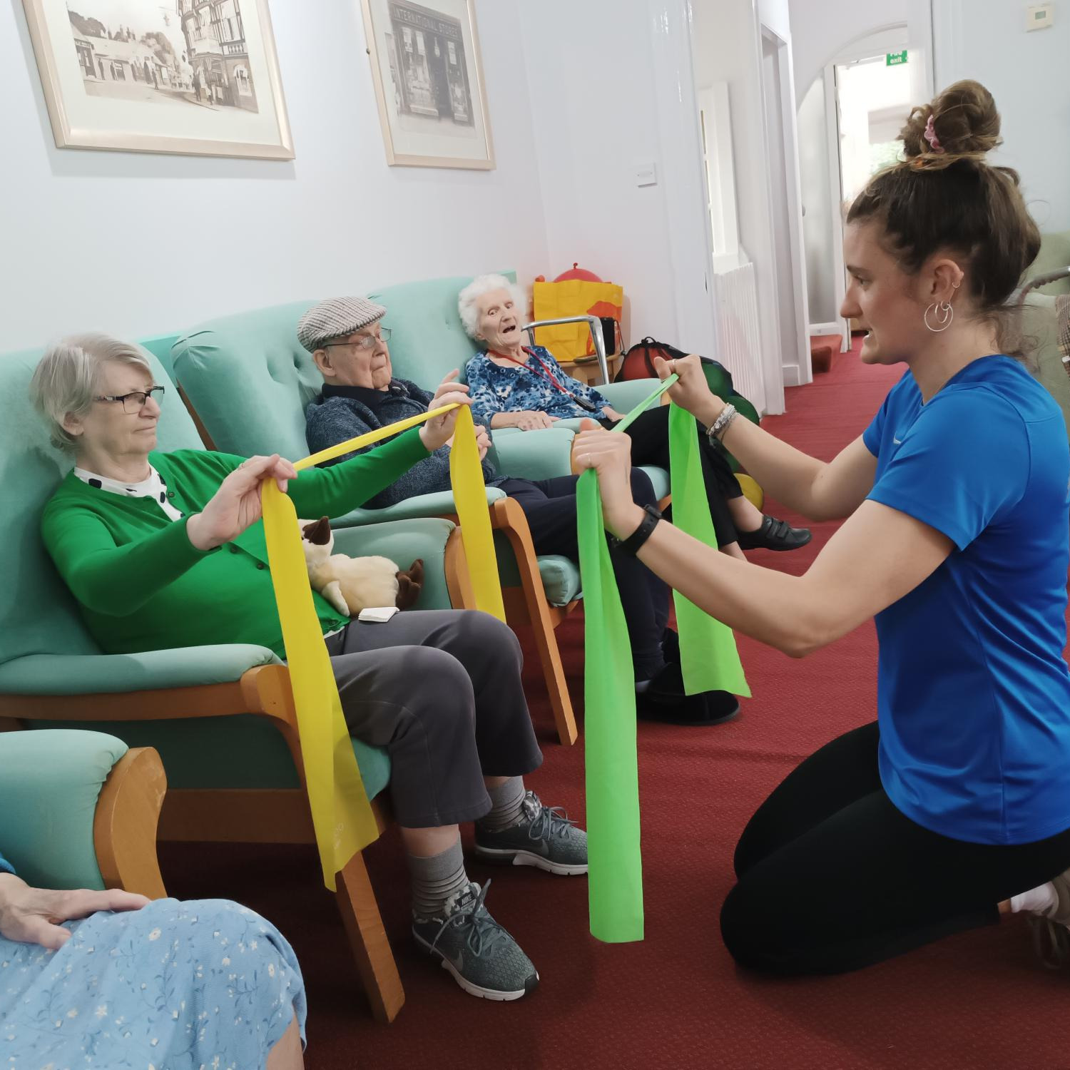 A group of people being guided through some gentle exercises