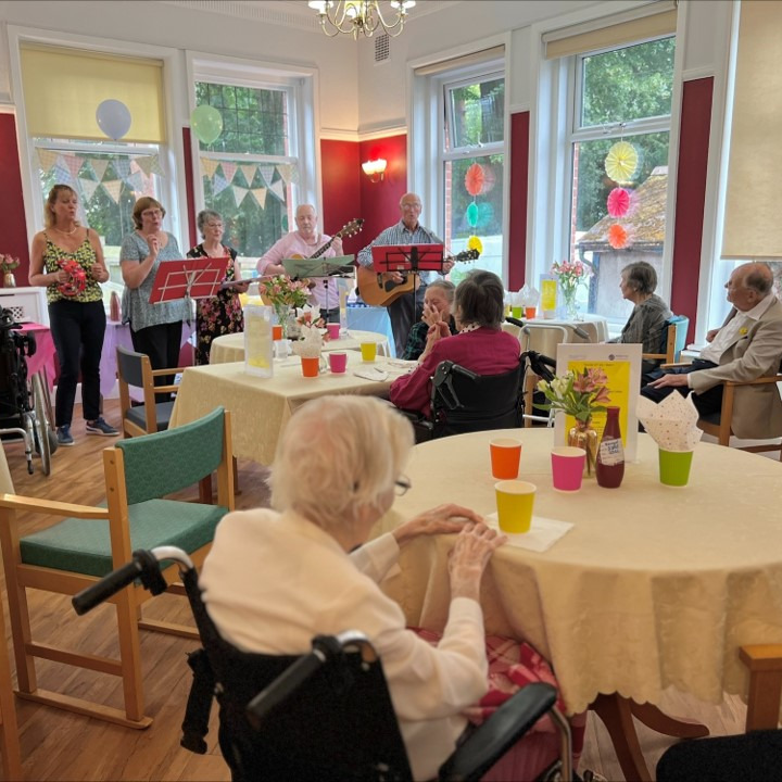A group of people at a party sat watching musical performers